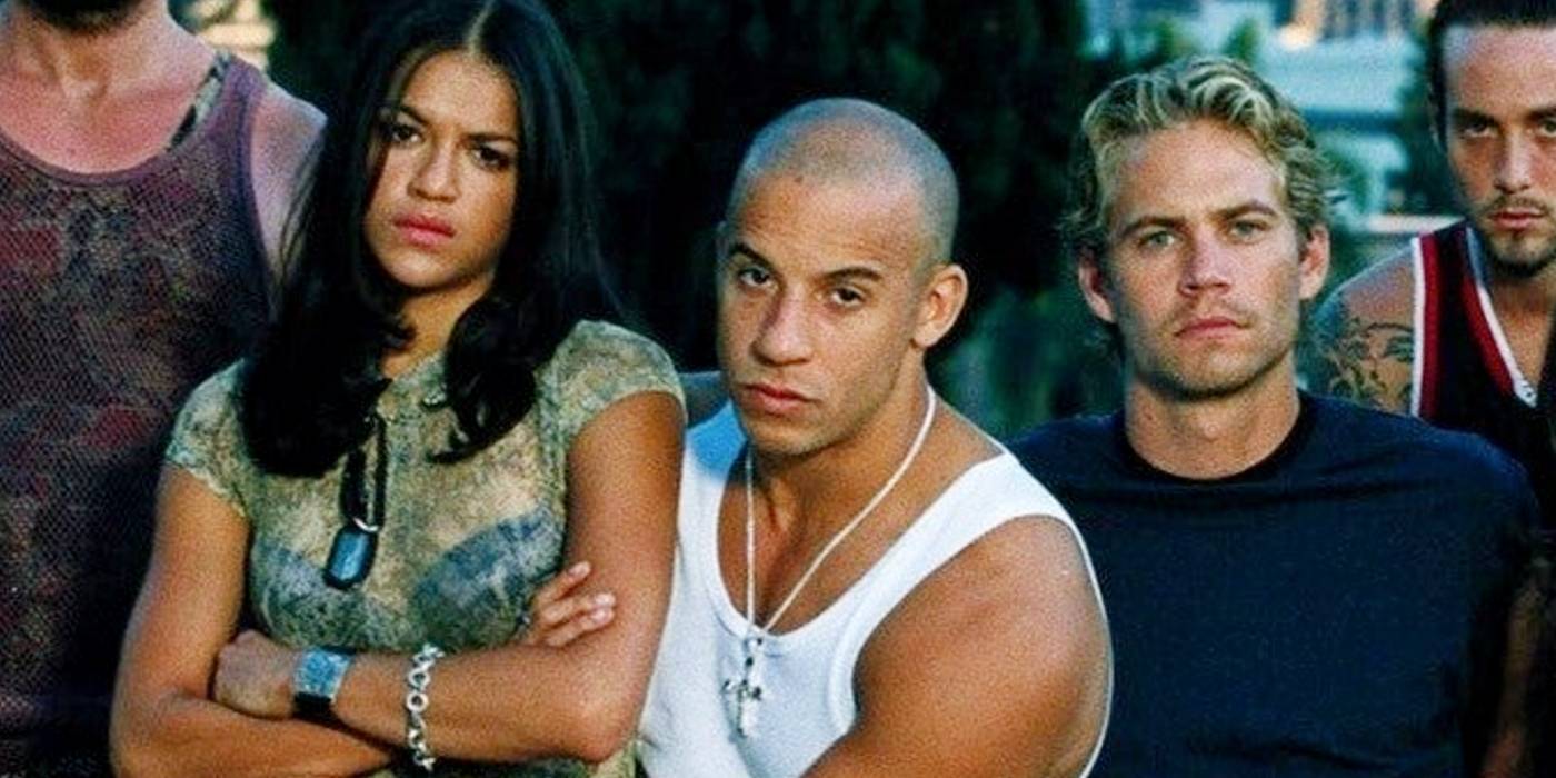 Актеры фильма "The Fast and the Furious 2001": Вин Дизель, Мишель Родригес, Пол Уокер, стоящие вместе