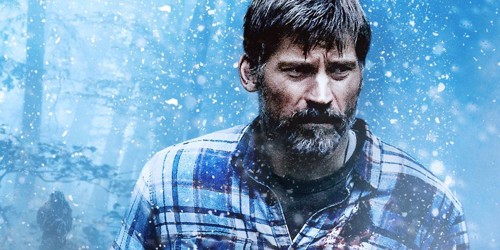 Rayburn stands in front of a blue background with white speckles in The Silencing.