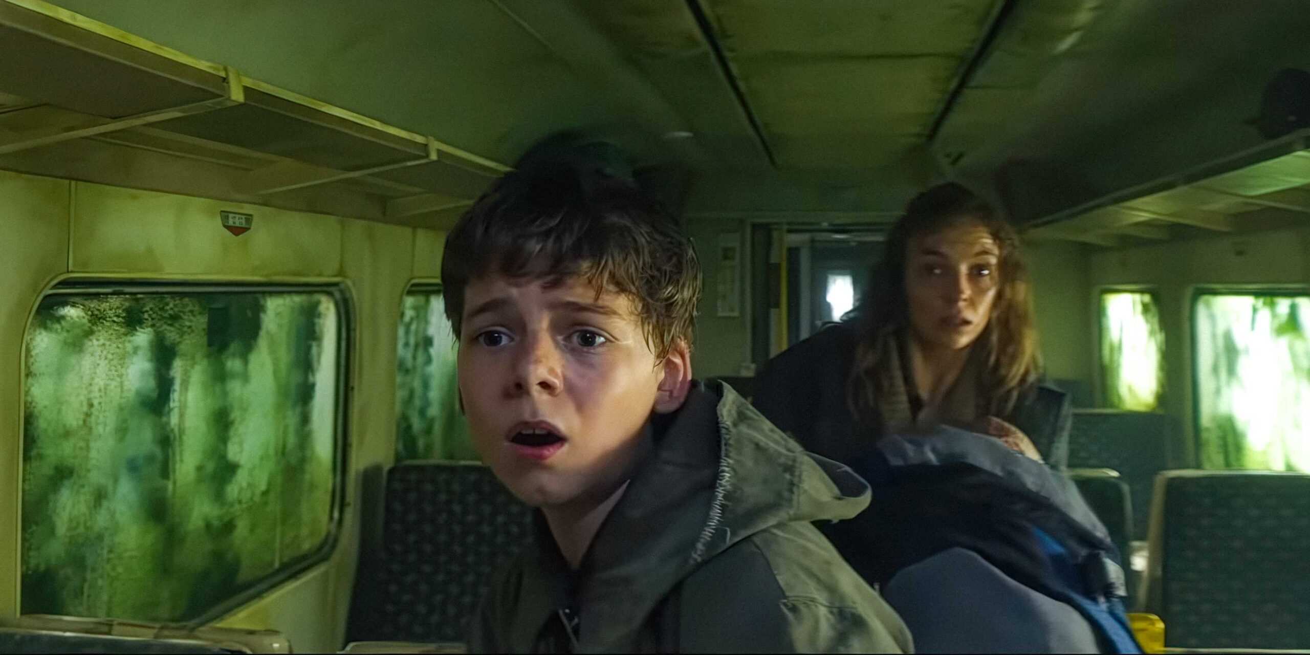 Спайк (Али Филли) и Исла (Джоди Комер) испуганно смотрят в поезд в фильме "28 Years Later"
