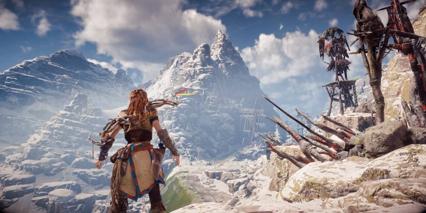 Изображение Алой, смотрящей на горы в Horizon Zero Dawn.