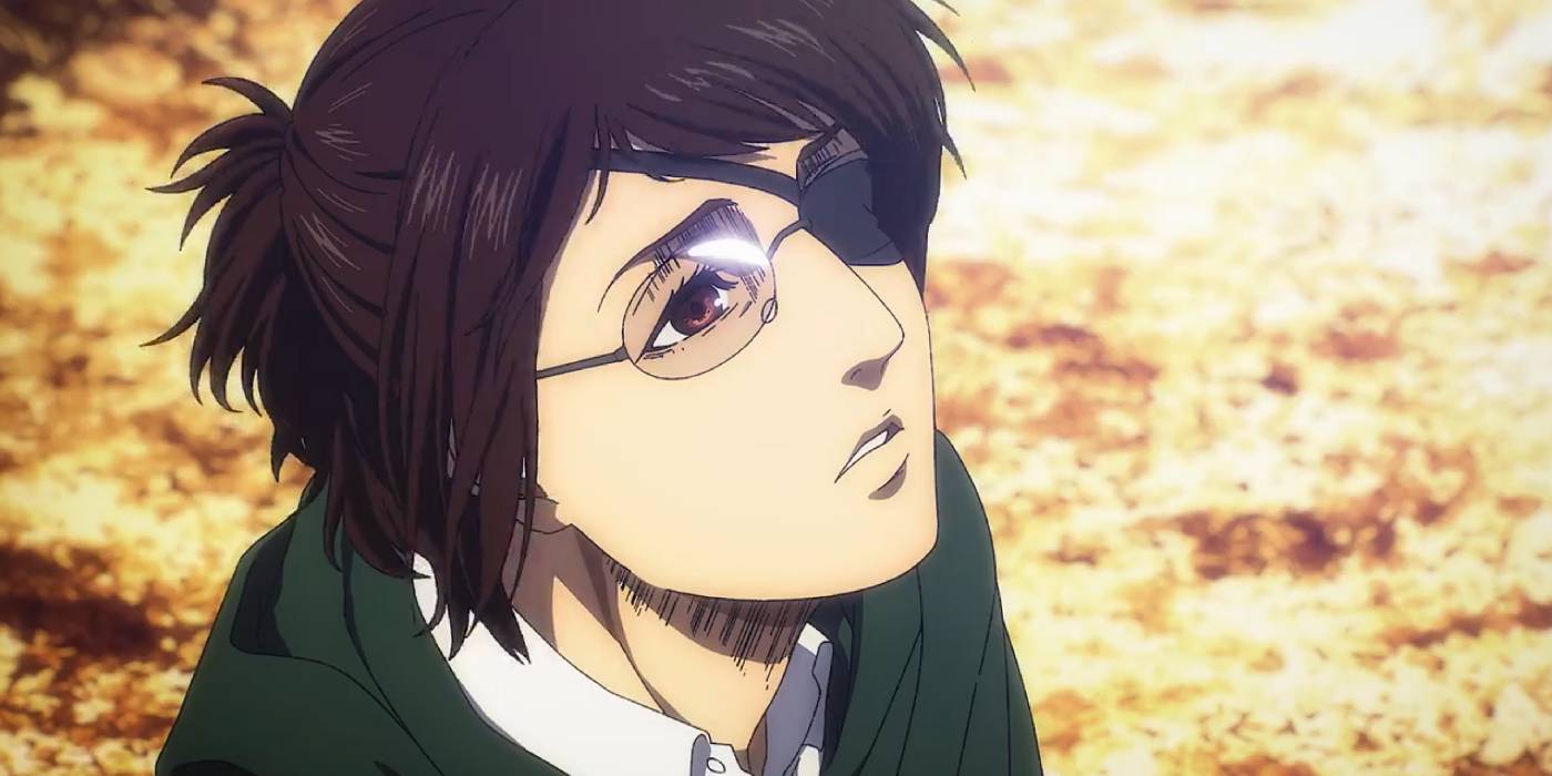 Ханге Зо из "Атаки титанов" смотрит вверх с угрюмым выражением отчаяния в глазах.