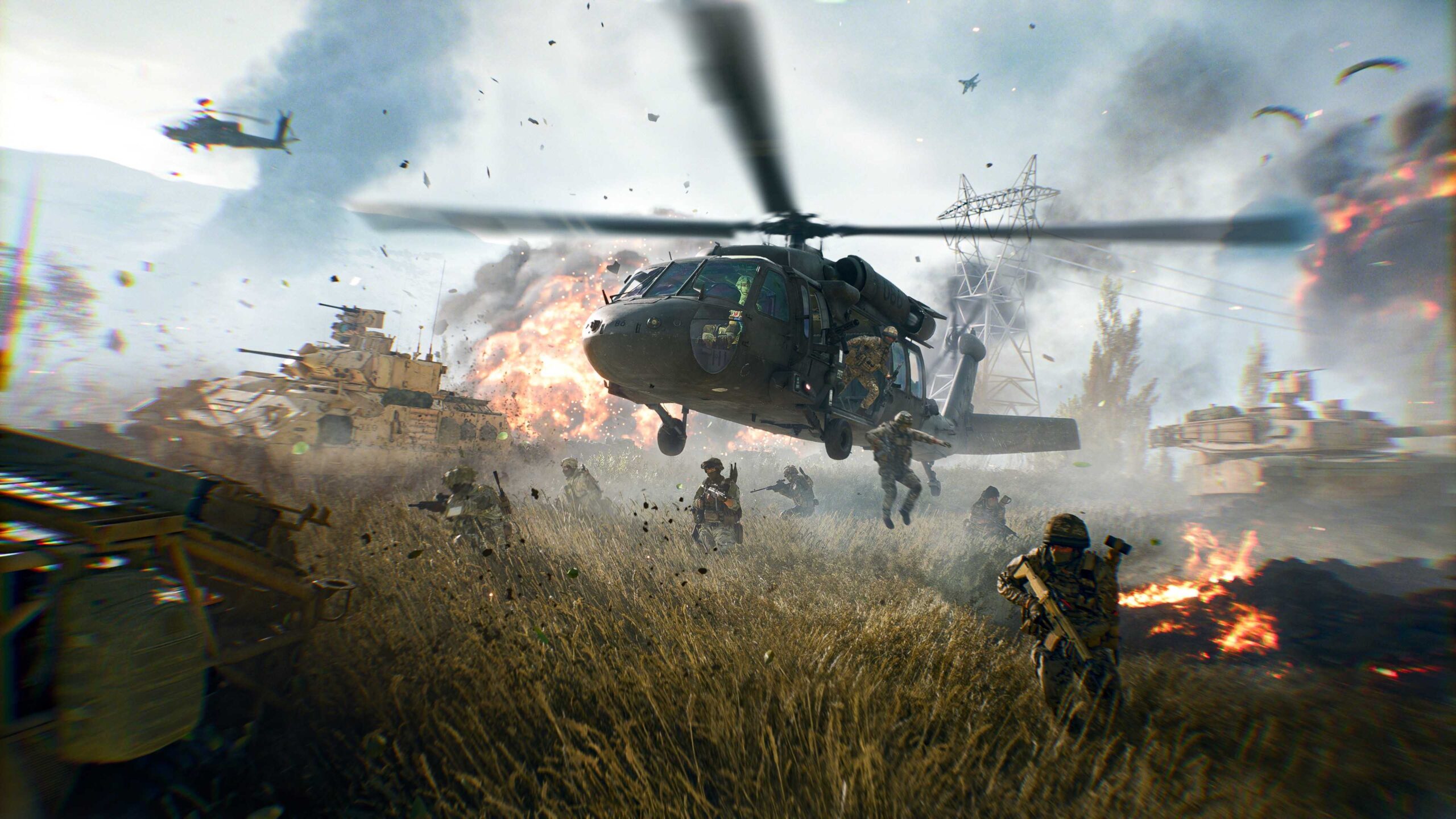 Вертолет Blackhawk в Battlefield 6, высаживающий пехоту, в то время как бронированные транспортные средства находятся поблизости.