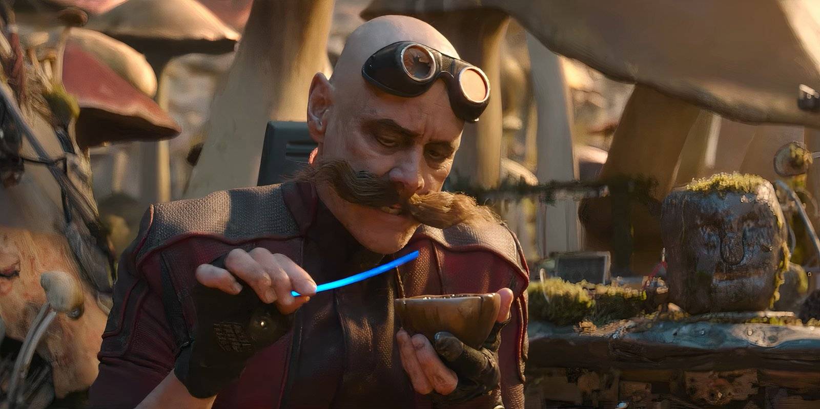 Джим Керри в роли доктора Роботник, держащий чашку рядом с камнем с лицом - Sonic the Hedgehog 2